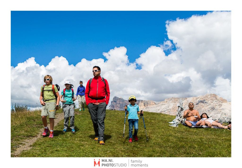A family hikes in the Dolomites Mountains 