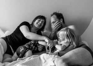 Family of 4 waking up during a documentary photo session