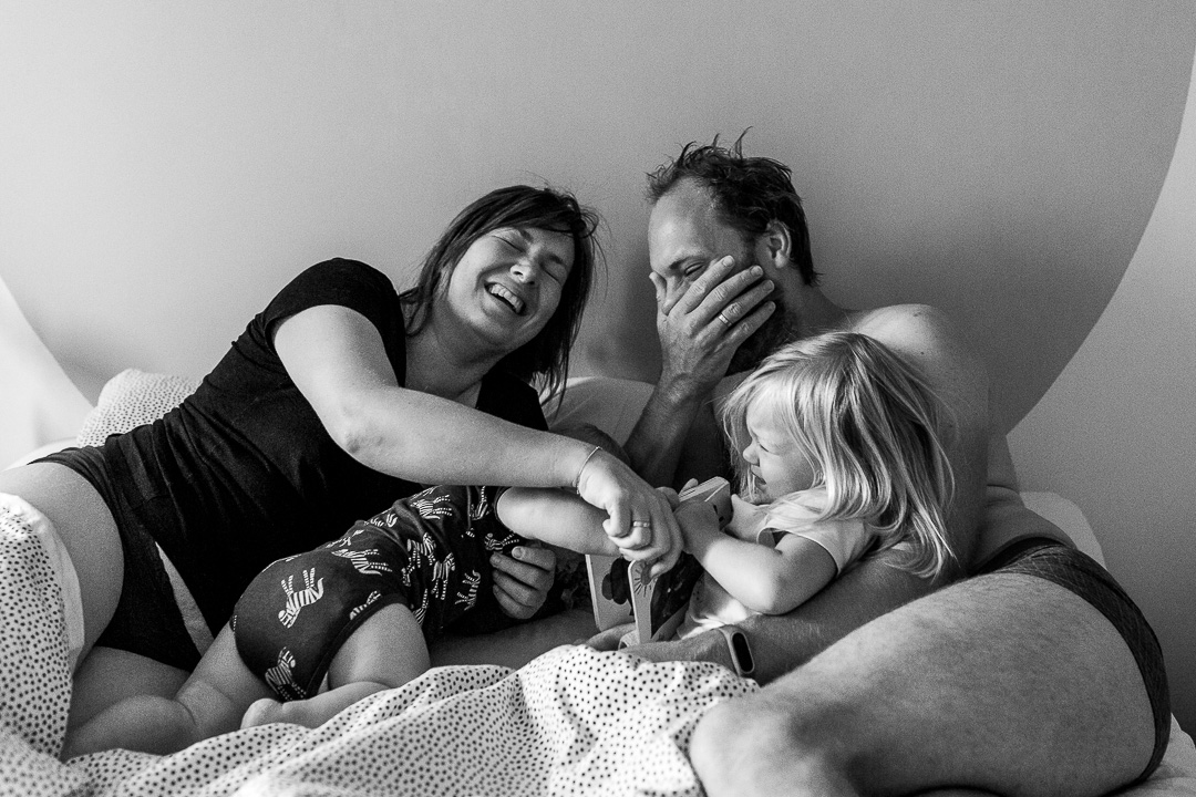 Family of 4 waking up during a documentary photo session